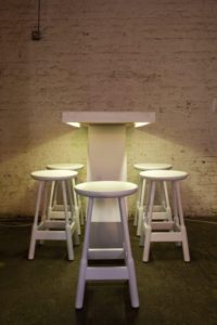 Bar table and stools lit by warm white LEDs