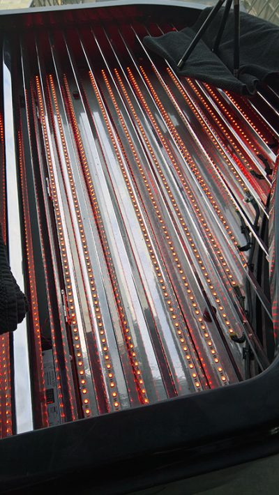 Fitting the LED strips in rows within the custom-built piano case