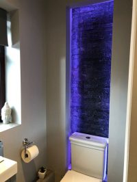 Bare brick feature wall in ensuite bathroom lit by LEDs - view 2