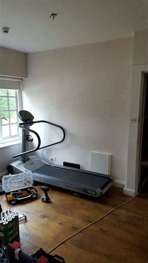 Treadmill in a room before the paneling and LED Tape has been installed