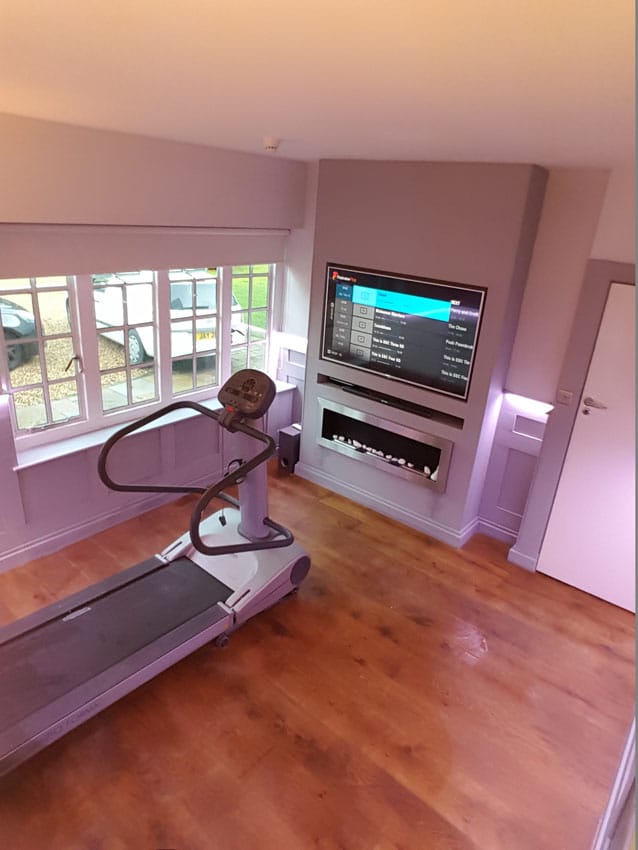 Treadmill in a room after the paneling and LED Tape has been installed