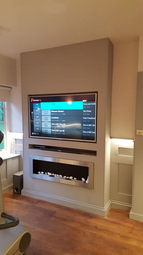 TV on the wall after the paneling and LED Tape has been installed